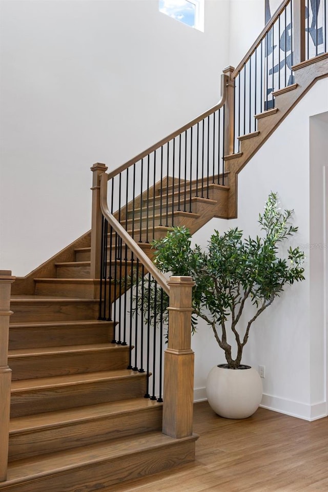 9352 Santorini Dr, Orlando, FL 32827 - stairway with baseboards and wood finished floors