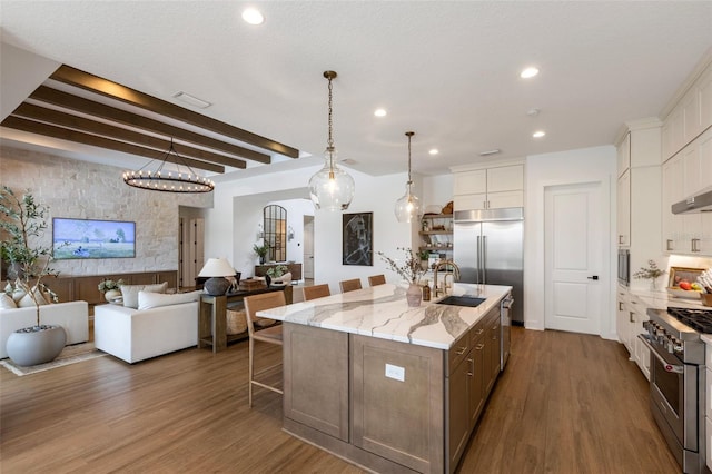 9352 Santorini Dr, Orlando, FL 32827 - kitchen with built in appliances, white cabinets, dark wood-style floors, recessed lighting, and beamed ceiling