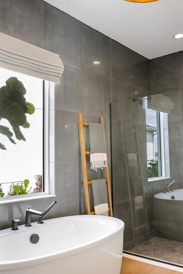 9352 Santorini Dr, Orlando, FL 32827 - bathroom with plenty of natural light and a freestanding bath