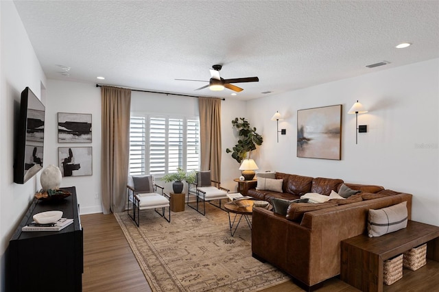 9352 Santorini Dr, Orlando, FL 32827 - living room featuring a ceiling fan, a textured ceiling, wood finished floors, and recessed lighting