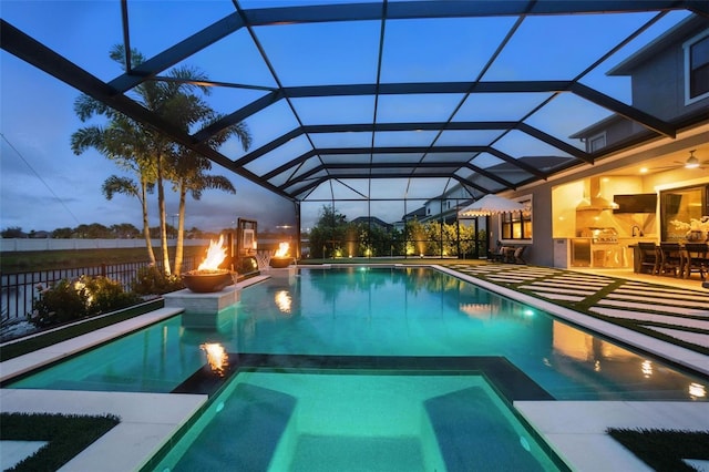 9352 Santorini Dr, Orlando, FL 32827 - view of pool with a pool with connected hot tub, an outdoor kitchen, a patio area, and a lanai