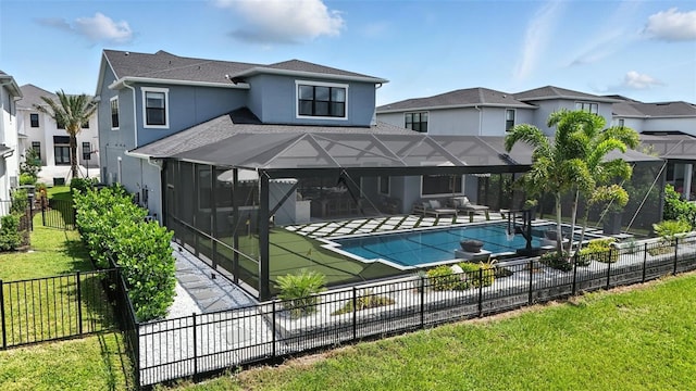 9352 Santorini Dr, Orlando, FL 32827 - back of house with a fenced backyard, a patio, stucco siding, a shingled roof, and glass enclosure