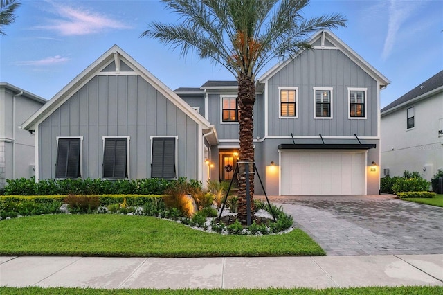 9352 Santorini Dr, Orlando, FL 32827 - view of front of property featuring board and batten siding, an attached garage, decorative driveway, and a front yard