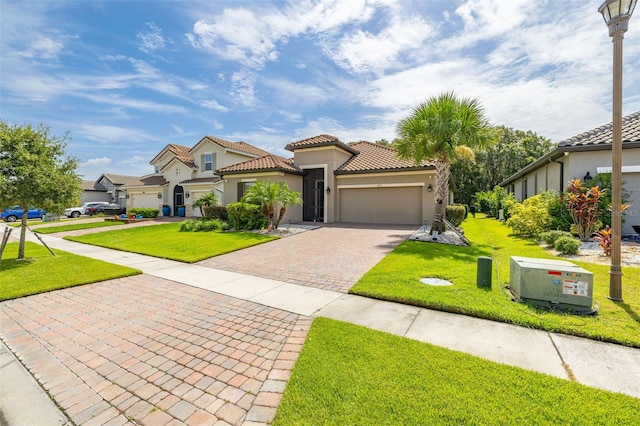 3837 Carrick Bend Dr, Kissimmee, FL 34746 - mediterranean / spanish-style home with stucco siding, decorative driveway, an attached garage, and a front yard