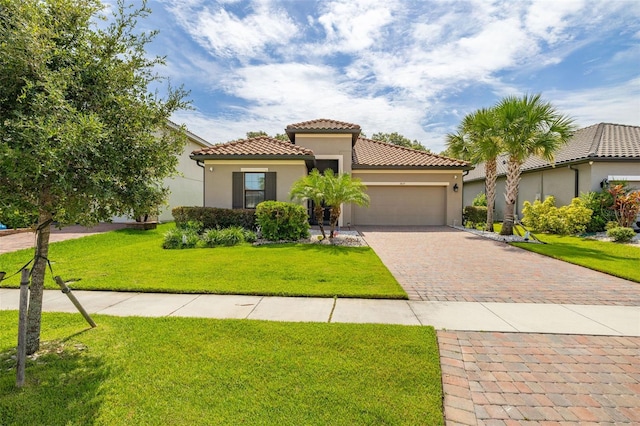 3837 Carrick Bend Dr, Kissimmee, FL 34746 - mediterranean / spanish home featuring stucco siding, an attached garage, driveway, a tile roof, and a front lawn