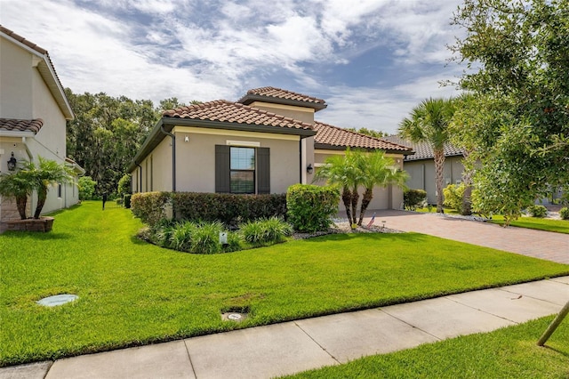 3837 Carrick Bend Dr, Kissimmee, FL 34746 - mediterranean / spanish-style house featuring decorative driveway, stucco siding, a tiled roof, a garage, and a front yard