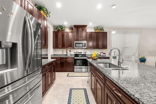 3837 Carrick Bend Dr, Kissimmee, FL 34746 - kitchen featuring stainless steel appliances, stone countertops, recessed lighting, hanging light fixtures, and dark brown cabinetry