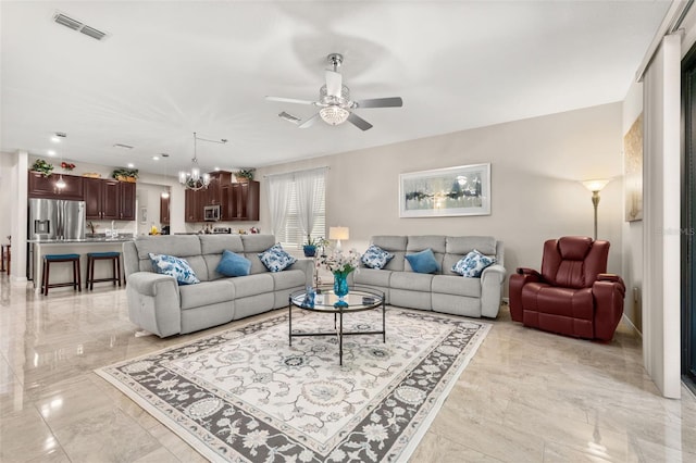 3837 Carrick Bend Dr, Kissimmee, FL 34746 - living room featuring light marble finish floors, a ceiling fan, and a chandelier