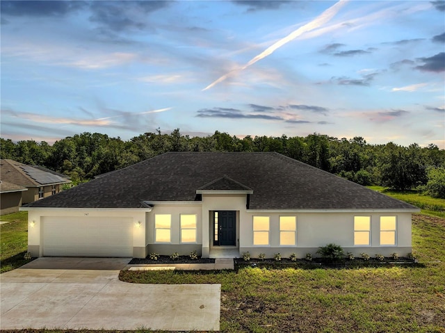 547 Viceroy Ct, Kissimmee, FL 34758 - ranch-style house featuring a shingled roof, stucco siding, a garage, driveway, and a front lawn