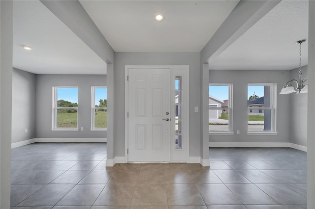 547 Viceroy Ct, Kissimmee, FL 34758 - entryway featuring healthy amount of natural light, a chandelier, and tile patterned floors