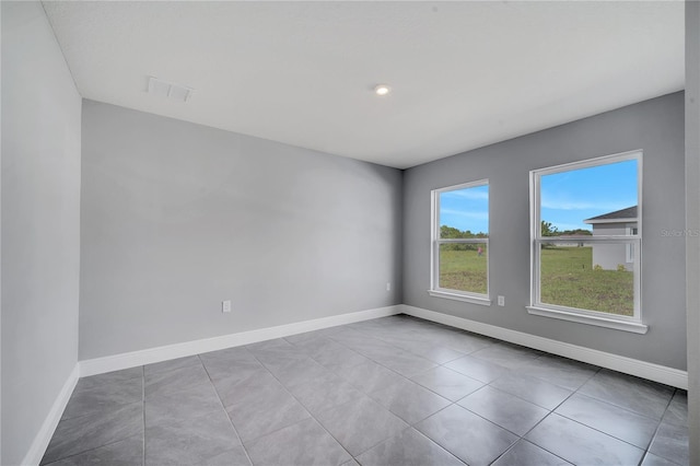 547 Viceroy Ct, Kissimmee, FL 34758 - tiled spare room featuring baseboards