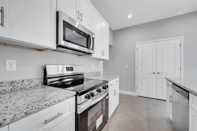 547 Viceroy Ct, Kissimmee, FL 34758 - kitchen with stainless steel appliances, white cabinetry, light stone countertops, and recessed lighting