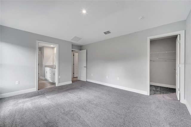 547 Viceroy Ct, Kissimmee, FL 34758 - unfurnished bedroom featuring carpet floors, a walk in closet, connected bathroom, and a closet