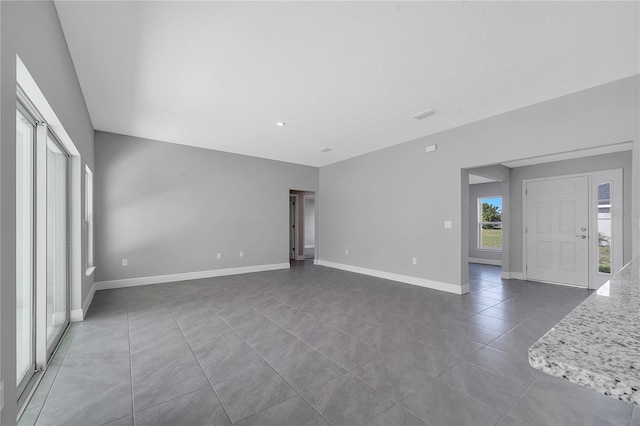 547 Viceroy Ct, Kissimmee, FL 34758 - unfurnished living room with tile patterned flooring and baseboards