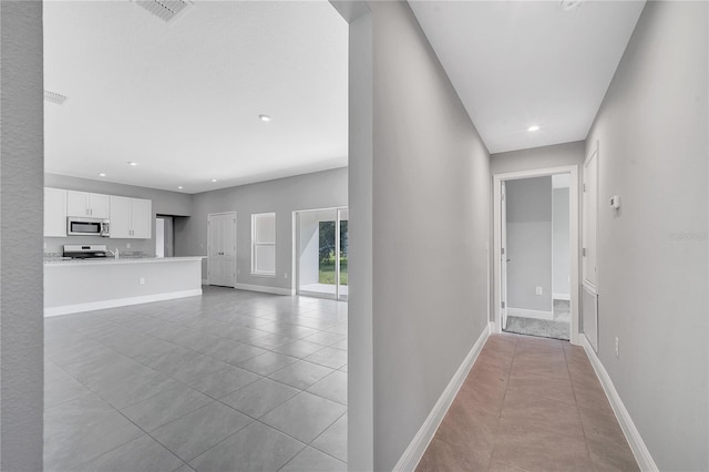547 Viceroy Ct, Kissimmee, FL 34758 - hallway with light tile patterned floors and recessed lighting