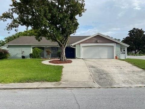12215 Cobble Stone Dr, Hudson, FL 34667 - ranch-style home featuring driveway, an attached garage, and a front lawn