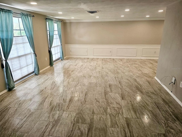12215 Cobble Stone Dr, Hudson, FL 34667 - empty room with a decorative wall, wainscoting, and recessed lighting