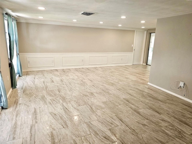12215 Cobble Stone Dr, Hudson, FL 34667 - empty room with a decorative wall, wainscoting, and recessed lighting