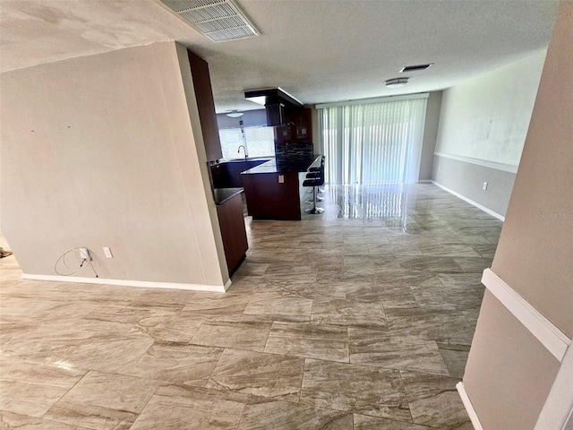 12215 Cobble Stone Dr, Hudson, FL 34667 - corridor with baseboards and a textured ceiling