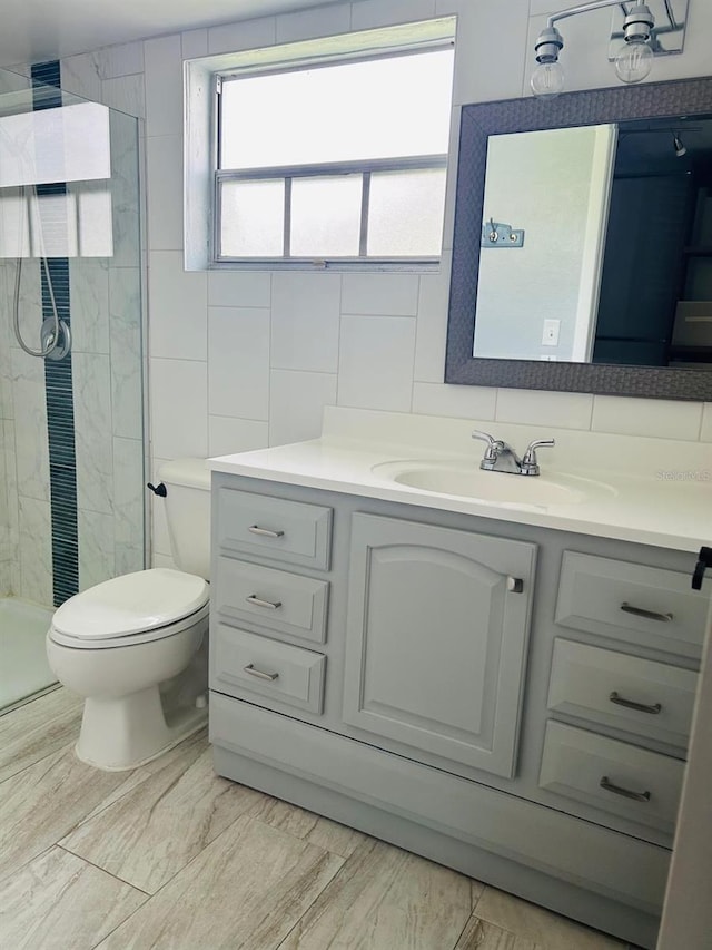 12215 Cobble Stone Dr, Hudson, FL 34667 - bathroom featuring vanity, tile walls, and a stall shower