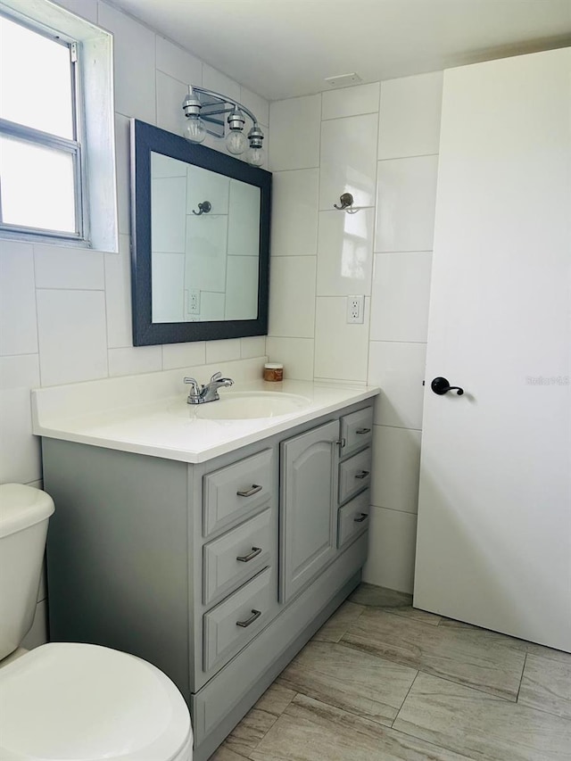 12215 Cobble Stone Dr, Hudson, FL 34667 - bathroom with tile walls and vanity