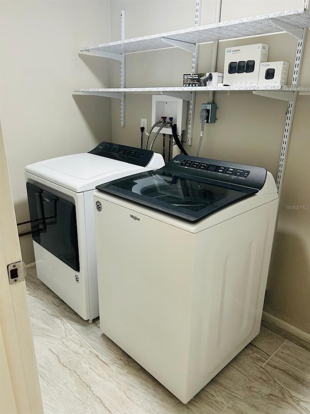12215 Cobble Stone Dr, Hudson, FL 34667 - washroom featuring washer and clothes dryer and baseboards