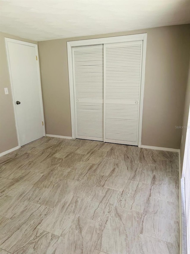 12215 Cobble Stone Dr, Hudson, FL 34667 - unfurnished bedroom featuring a closet and baseboards