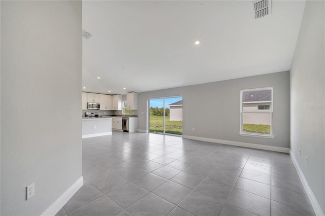 549 Viceroy Ct, Kissimmee, FL 34758 - unfurnished living room featuring light tile patterned flooring and recessed lighting