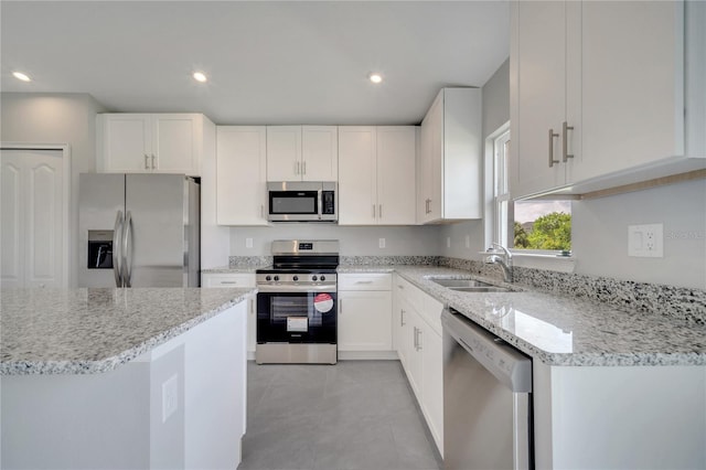 549 Viceroy Ct, Kissimmee, FL 34758 - kitchen with appliances with stainless steel finishes, white cabinetry, light stone counters, and recessed lighting