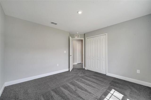 549 Viceroy Ct, Kissimmee, FL 34758 - unfurnished bedroom featuring dark colored carpet, a closet, and recessed lighting