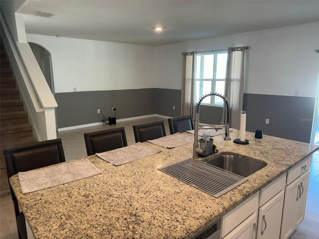 636 Autumn Stream Drive St, Auburndale, FL 33823 - kitchen with white cabinetry, open floor plan, light stone countertops, and recessed lighting