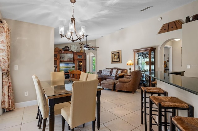 1525 Gants Cir, Kissimmee, FL 34744 - dining space with arched walkways, a chandelier, and light tile patterned floors