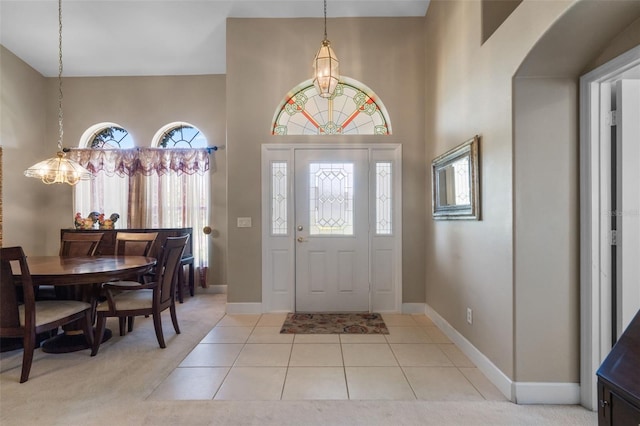 1525 Gants Cir, Kissimmee, FL 34744 - entrance foyer with light tile patterned flooring, a chandelier, and a towering ceiling