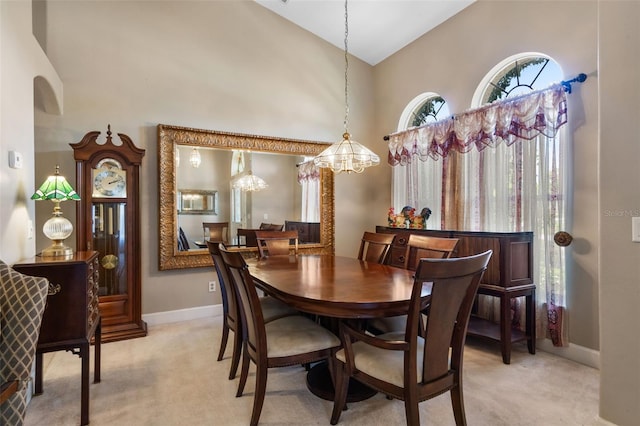 1525 Gants Cir, Kissimmee, FL 34744 - dining room with light colored carpet, high vaulted ceiling, and a chandelier