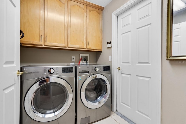 1525 Gants Cir, Kissimmee, FL 34744 - laundry area featuring separate washer and dryer, cabinet space, and light tile patterned floors