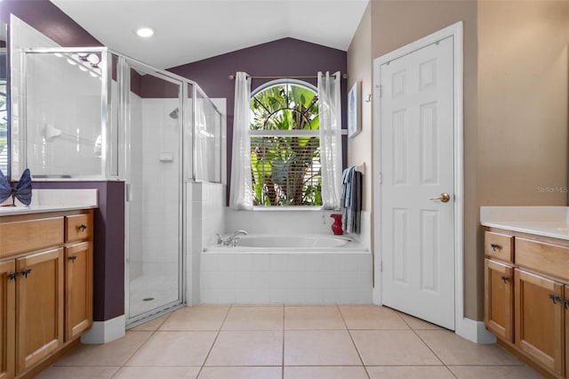 1525 Gants Cir, Kissimmee, FL 34744 - full bathroom with vanity, a stall shower, a bath, healthy amount of natural light, and vaulted ceiling