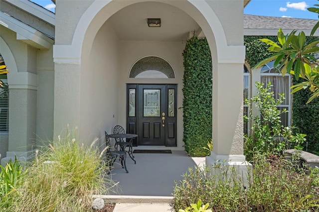 1525 Gants Cir, Kissimmee, FL 34744 - view of exterior entry featuring stucco siding and roof with shingles