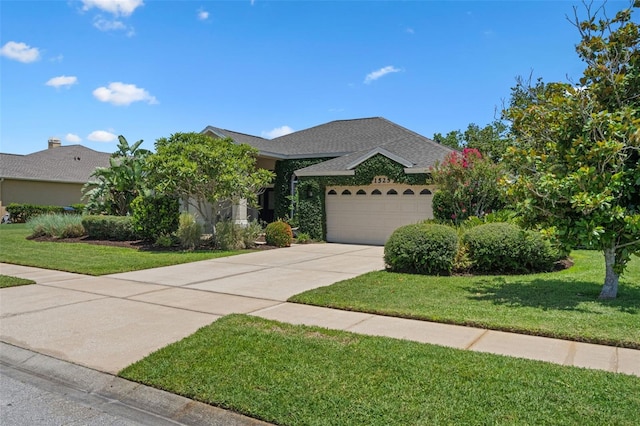 1525 Gants Cir, Kissimmee, FL 34744 - view of front of home with an attached garage, a front yard, driveway, and a shingled roof