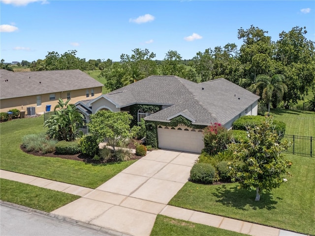 1525 Gants Cir, Kissimmee, FL 34744 - view of front of home featuring an attached garage, driveway, and roof with shingles