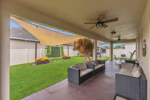 1864 Castleton Dr, Saint Cloud, FL 34771 - fenced backyard with a patio area, outdoor lounge area, and ceiling fan