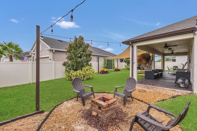 1864 Castleton Dr, Saint Cloud, FL 34771 - fenced backyard with ceiling fan, a patio, and an outdoor living space with a fire pit