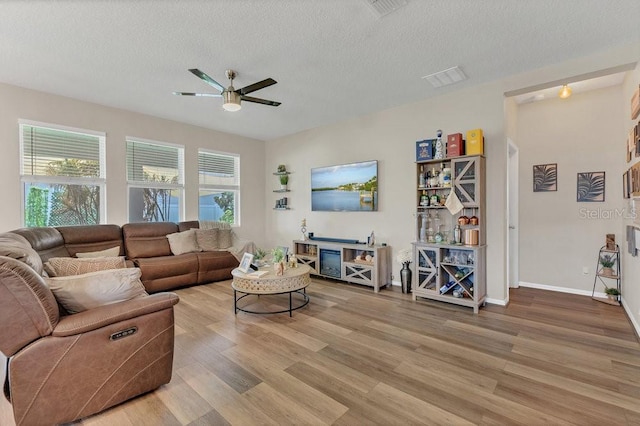 1864 Castleton Dr, Saint Cloud, FL 34771 - living area with a ceiling fan, wood finished floors, and a textured ceiling