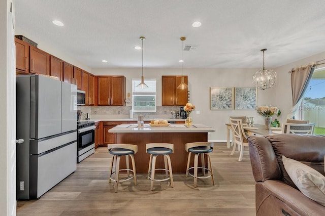 1864 Castleton Dr, Saint Cloud, FL 34771 - kitchen featuring stainless steel appliances, open floor plan, healthy amount of natural light, light countertops, and recessed lighting