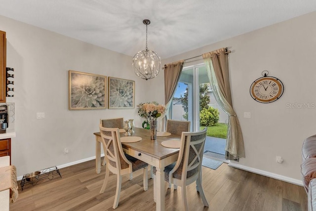 1864 Castleton Dr, Saint Cloud, FL 34771 - dining area with a chandelier and light wood finished floors