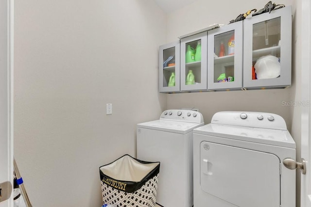 1864 Castleton Dr, Saint Cloud, FL 34771 - laundry room featuring cabinet space and separate washer and dryer