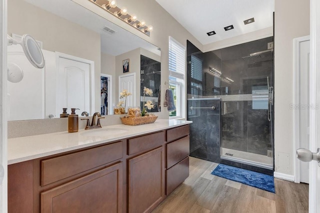 1864 Castleton Dr, Saint Cloud, FL 34771 - full bathroom with a stall shower, vanity, and wood finished floors