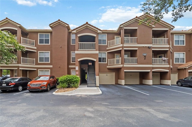 8836 Villa View Cir Unit 303, Orlando, FL 32821 - view of apartment building / complex with an attached garage