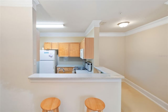 8836 Villa View Cir Unit 303, Orlando, FL 32821 - kitchen with white appliances, ornamental molding, a breakfast bar, light countertops, and a peninsula