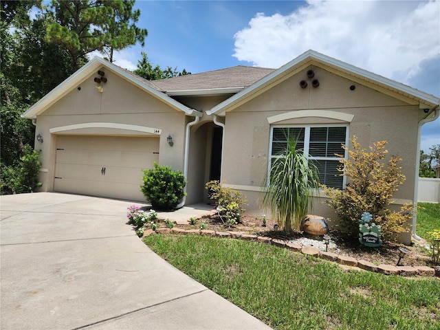 144 Hawthorne Way, Davenport, FL 33896 - view of front of house featuring an attached garage, driveway, and stucco siding