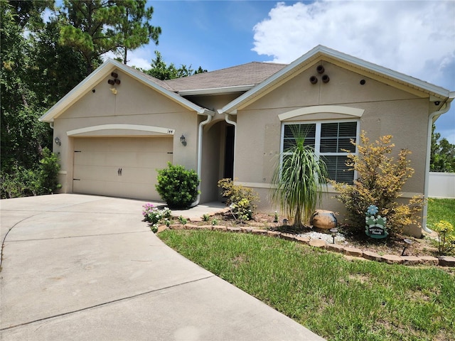 144 Hawthorne Way, Davenport, FL 33896 - view of front of house with an attached garage, stucco siding, and driveway